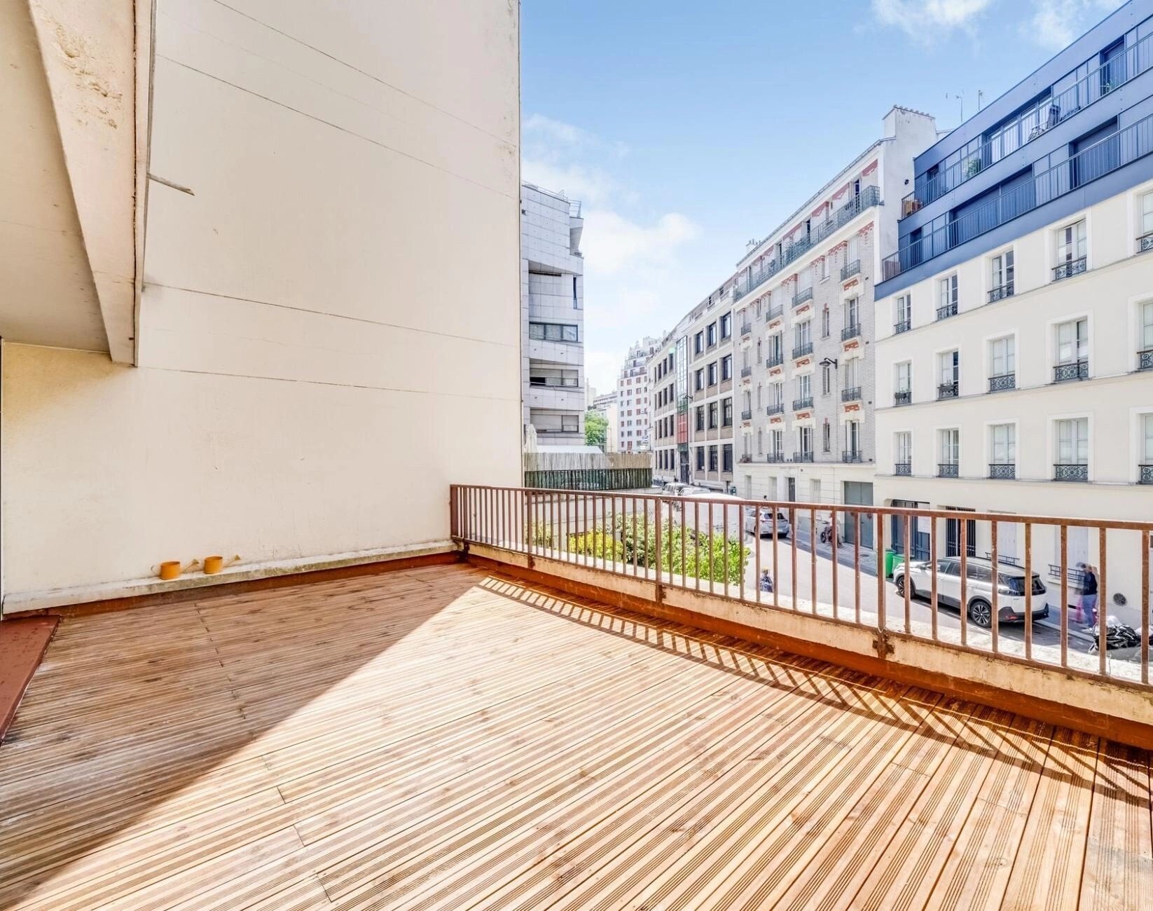Terrasse en lames de bois après travaux, ouverte sur la rue